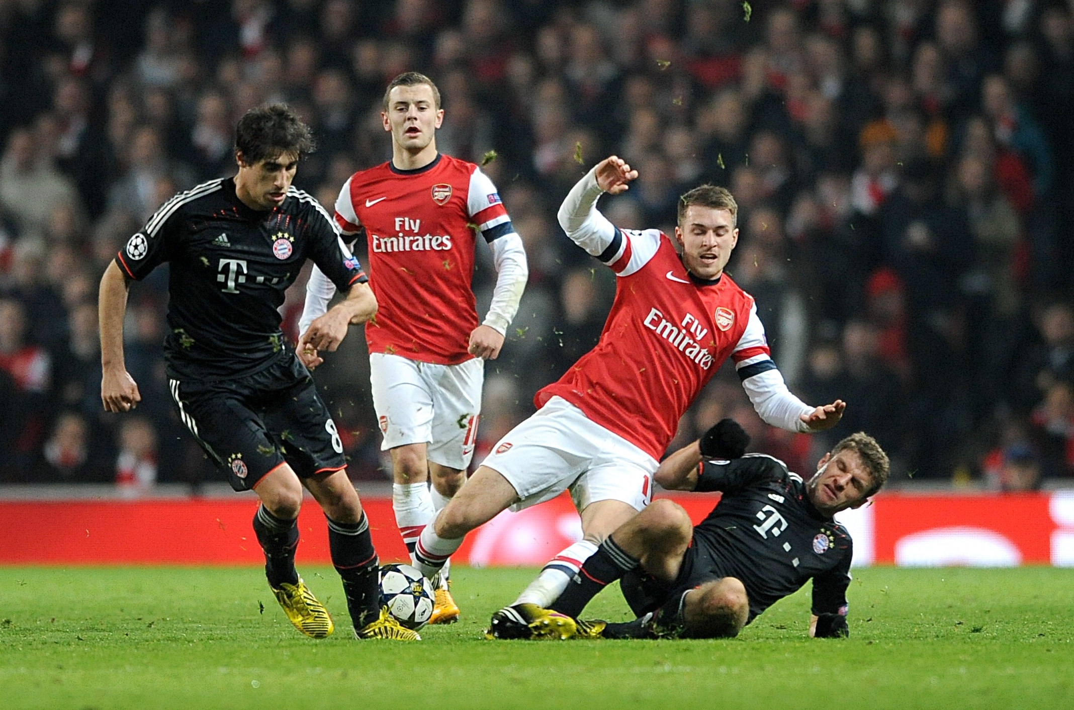 Bayern Munich's Thomas Muller (right) and Arsenal's Aaron Ramsey battle for the ball during the UEFA Champions League match at Emirates Stadium, London. PRESS ASSOCIATION Photo. Picture date: Tuesday February 19, 2013. See PA story SOCCER Arsenal. Photo credit should read: Anthony Devlin/PA Wire